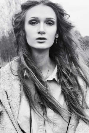 portrait of beautiful model woman with curly hair in black and whiteの写真素材