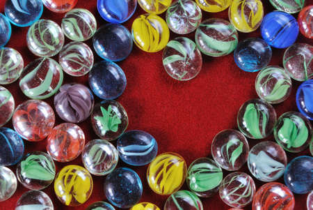 decoration pebbles stones heart shaped on red velvet backgroundの写真素材