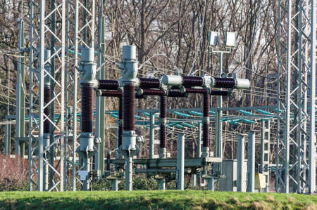 power plant with isolation objects in front of treesの写真素材