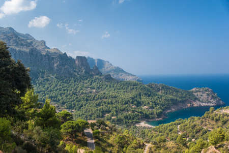 Panoramic view of Cala Tuent and the Mediterranean Sea on a sunny day.の写真素材