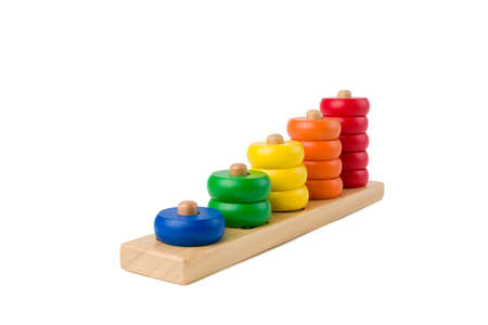 Colorful wooden children toy scores from one to five figures of the colored rings isolated on a white background. Focus stacking. Extreme depth of field.の写真素材