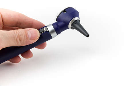 Hand Holding Medical Equipment Otoscope From Side, Isolated on White Background, Studio Shotの写真素材