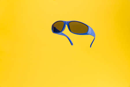 Color Children sunglasses isolated on yellow background. Concept of sun protection summer and vacation. Front view with copy space. Studio Shotの写真素材