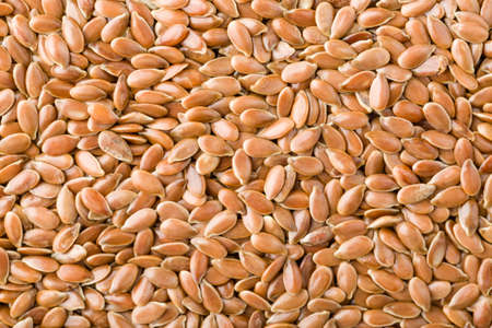Close up of brown flax seeds background, top view, studio shotの写真素材
