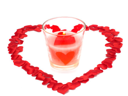 Heart, Symbol of Love and Valentine's Day with a candle in a glass isolated on white backgroundの写真素材