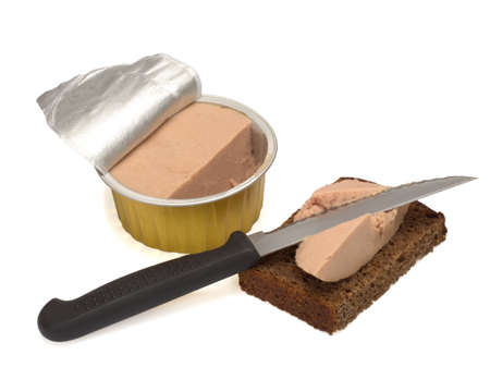 Metallic jar with poultry paste, black bread with a paste and a knife isolated on a white backgroundの写真素材