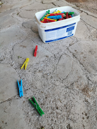 Washing pegs in bucket and on floor