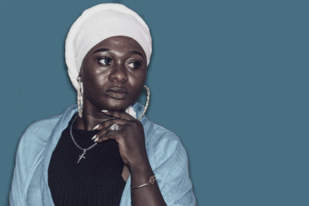 African woman in white headdress thinking about her futureの写真素材