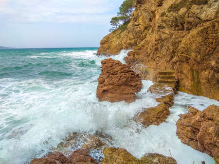 Waves hitting the rocks on the coastの写真素材