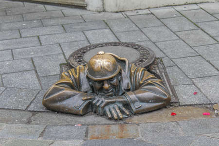 Slovakia, Bratislava - January 20,2020:Bronze sculpture called Cumil (The Watcher) or Man at work, Bratislava, Slovakiaのeditorial素材