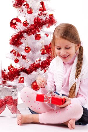 Happy little girl with Christmas present の写真素材