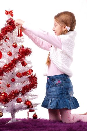 Girl decorating Christmas tree の写真素材