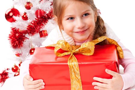 Beautiful girl embraces a gift package の写真素材