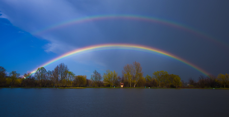double rainbow over the lakeの写真素材