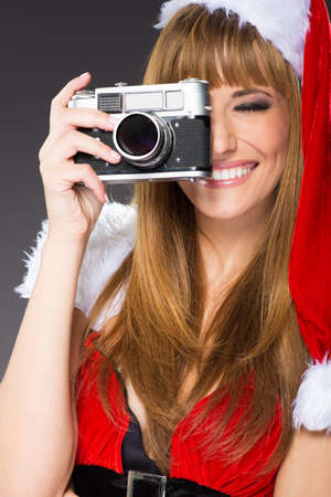 portrait of a santa woman with a old camera の写真素材