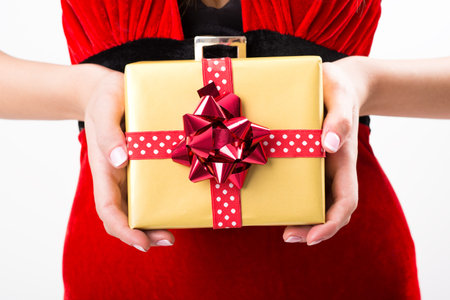 Portrait of young, sexy woman Santa with gift boxes