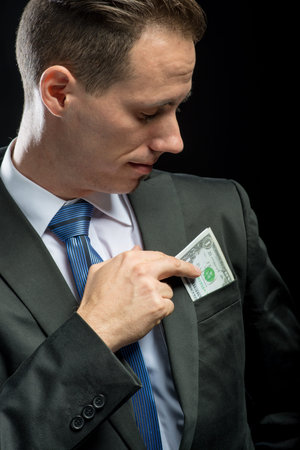 Businessman pulling their money out of pocket