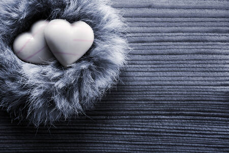  Heart-shaped chocolates in nest, wood backgroundの写真素材
