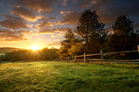 Picturesque landscape, fenced ranch at sunrise