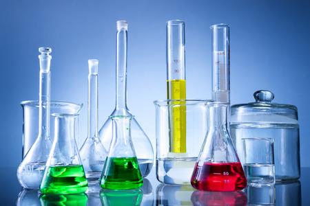 Laboratory equipment, bottles, flasks with color liquid  on blue backgroundの写真素材