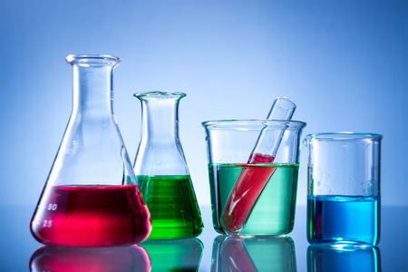 Laboratory equipment, bottles, flasks with color liquid  on blue backgroundの写真素材