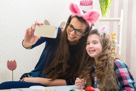 Easter - Mother and daughter with bunny ears, made Selfie photoの写真素材