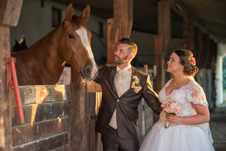 Beautiful young couple with horsesの写真素材