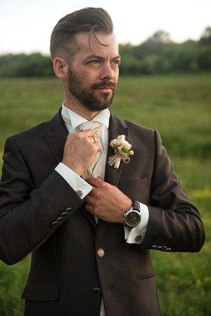 Young handsome groom portrait in natureの写真素材