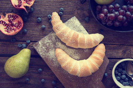 Beautiful, breakfast-like still life with crescent and fruitの写真素材