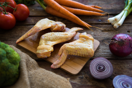 Raw Chicken wigs with mixed vegetableの写真素材