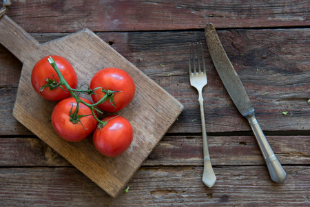 Fresh tomato on the wood plateの写真素材