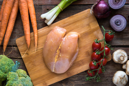 Raw Chicken breast with mixed vegetableの写真素材