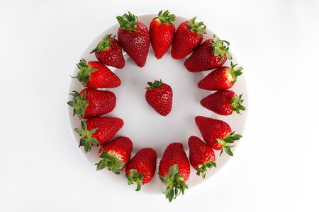 Strawberry healthy menu. Strawberries in a plate isolated on white background.の写真素材