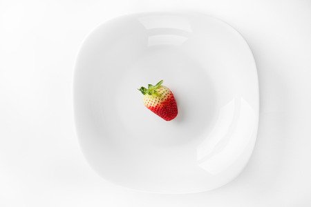 Fresh strawberry in porcelain dish isolated on white backgroundの写真素材