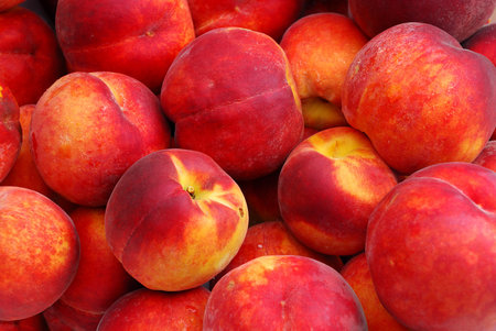 Background of a Fresh Organic Peaches background at a street marketの写真素材
