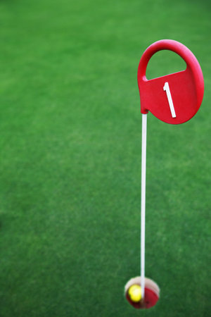 Golf ball at the holeの写真素材