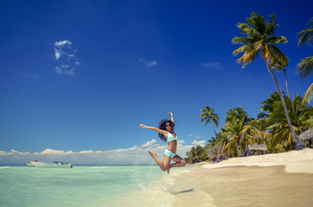 Carefree young woman relaxing on exotic tropical beachの写真素材