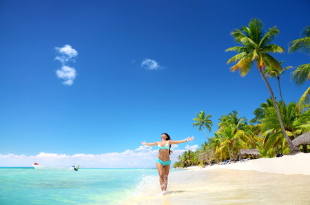 Carefree young woman relaxing on tropical beachの写真素材