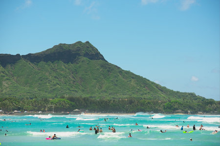 Waikiki Beach, HI, USA - July 23, 2019: People enjoying waves at Waikiki Beach.のeditorial素材