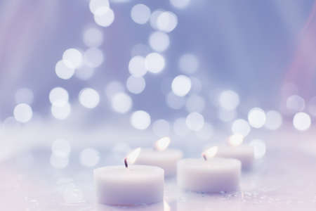 Burning tea light candles - selective focus with bokeh backgroundの写真素材