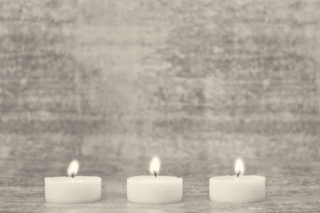 Burning tea light candles - selective focusの写真素材
