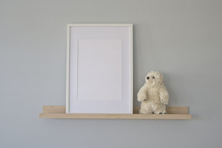 Interior frame mockup with empty frame on a wooden shelf