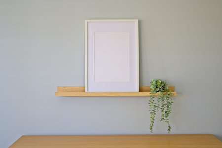 Interior frame mockup with empty frame on a wooden shelf