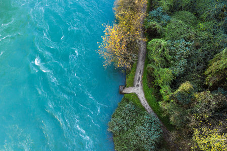 The rushing waters of the river crashing on the small stone pier.の写真素材