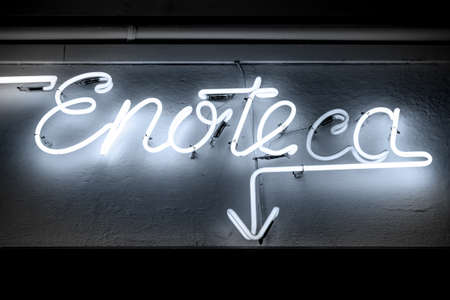 Blue neon signboard of INFORMS you in italian winehouse.の写真素材