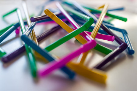 A series of colorful straws intertwine forming a carousel of color.