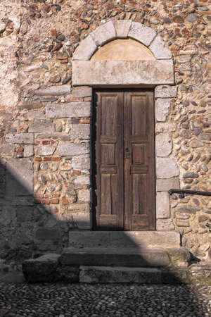 A side entrance to an ancient italian church medieval.の写真素材