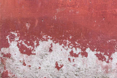 Detail of a wall with red plaster peeling.の写真素材