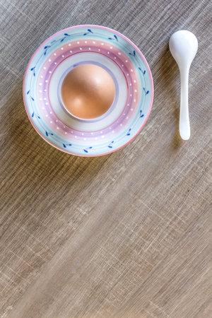 Overview from the top of a boiled egg with a teaspoon.