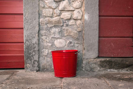 Red garbage bin at center stage.の写真素材